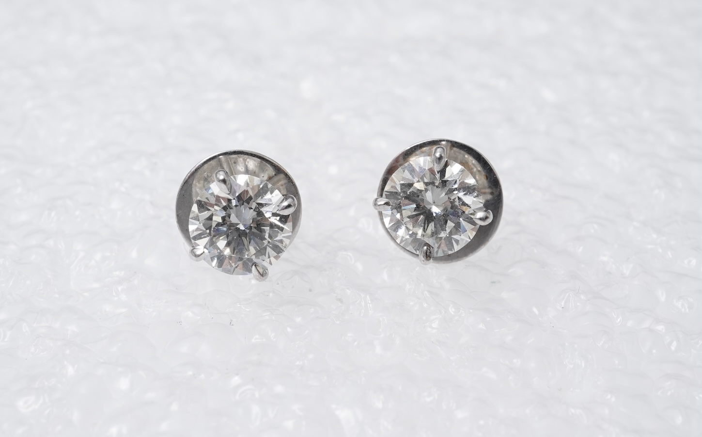 A pair of diamond stud earrings